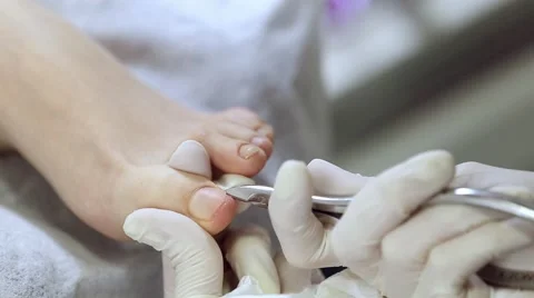 Removing cuticle with cuting forceps Stock Footage 61238682