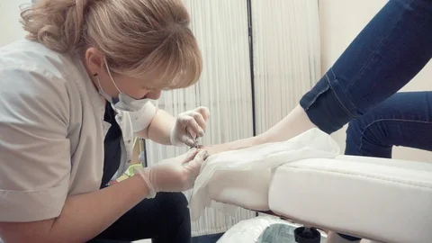Removing cuticles from toes Stock Footage 87825252