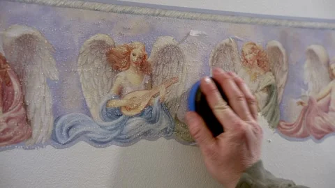 Removing decorative wallpaper border during home improvement project Stock Footage 306226306