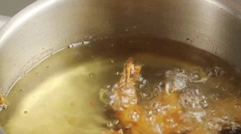 Removing deep-fried prawns from oil Stock Footage 24664772