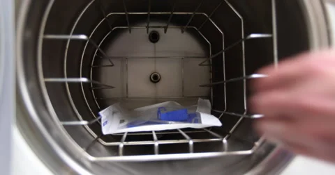 Removing Dental Equipment from Sterilizing Machine Stock Footage 57754883