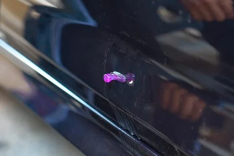 Removing dents on the car. PDR technology. Car body repair without painting. Stock Photos