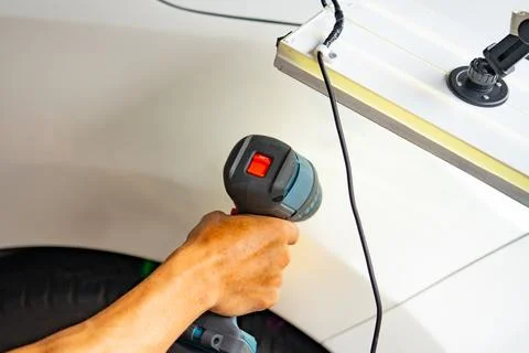 Removing dents on the car. PDR technology. Car body repair without painting. Stock Photos