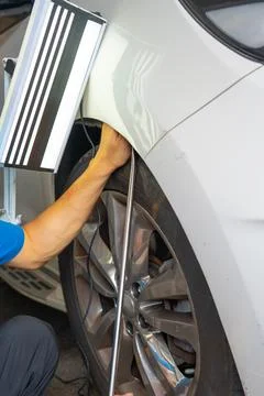 Removing dents on the car. PDR technology. Car body repair without painting. Stock Photos