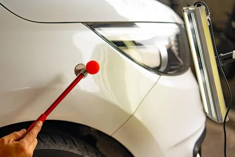 Removing dents on the car. PDR technology. Car body repair without painting. Stock Photos