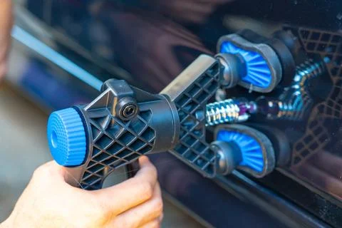 Removing dents on the car. PDR technology. Car body repair without painting. Stock Photos