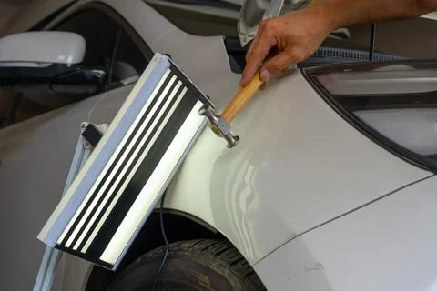 Removing dents on the car. PDR technology. Car body repair without painting. Stock Photos
