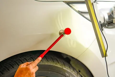 Removing dents on the car. PDR technology. Car body repair without painting. Stock Photos