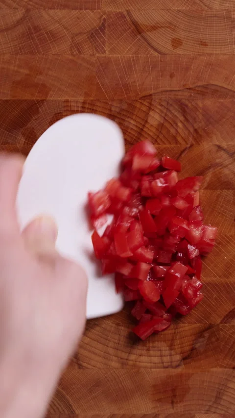 Removing Diced Tomatoes from Cutting Board Vertical Top View 스톡 동영상 336573243