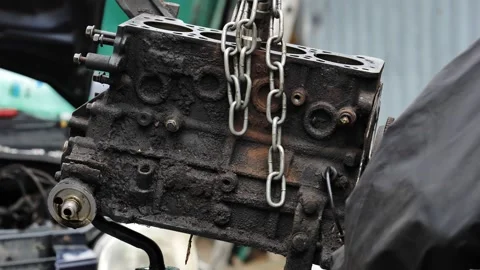 Removing dirty car engine block during auto repair Stock Footage 318140345