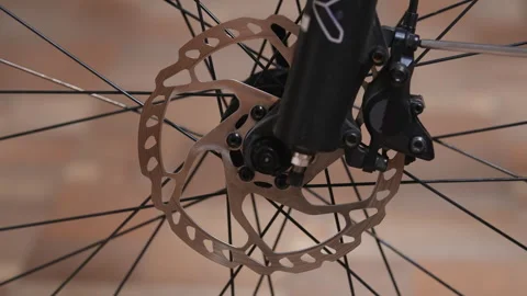 Removing a disc brake caliper from a bicycle suspension fork Stock Footage 280482783