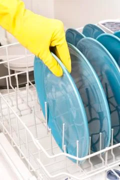 Removing dishes from dishwasher Stock Photos
