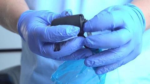 Removing a disposable needle from a tattoo machine Stock Footage 73397461