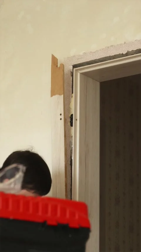 Removing door frame trim moulding with pry bar close up Stock Footage 340610712