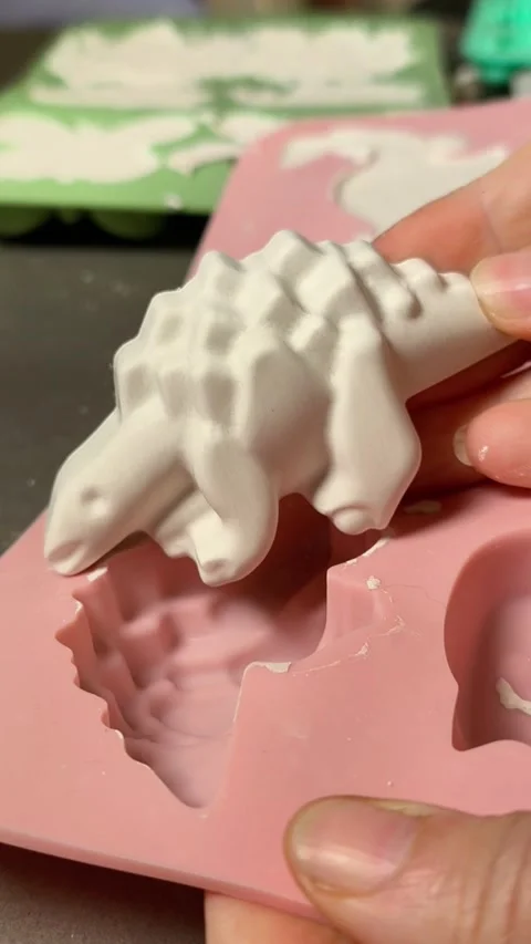 Removing dried plaster figure from silicone mold, Stock Footage 336621796