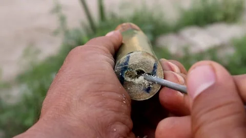 Removing the drilled material inside of the bamboo Stock Footage 150716587