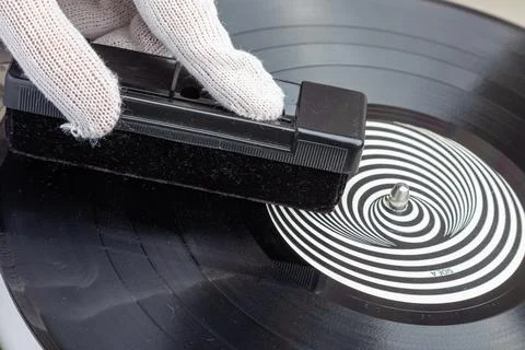 Removing dust from the vinyl record using a velvet brush Stock Photos