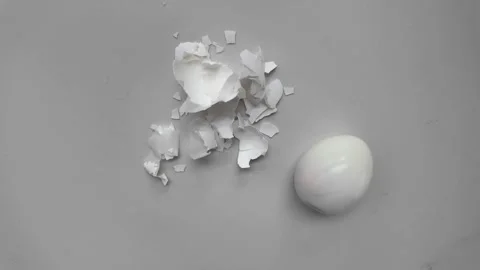 Removing eggshell from cooked egg food process Stock Footage 332059600