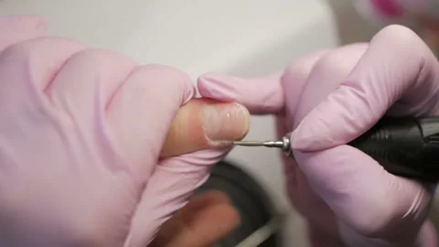 Removing excess cuticles using hardware manicure process in beauty salon. Video stock 105669152