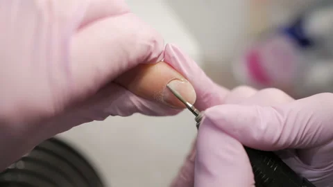 Removing excess cuticles using hardware manicure process in beauty salon. Stock-Footage 105675872