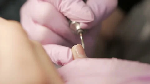 Removing excess cuticles using hardware manicure process in beauty salon. Stock Footage 105678028