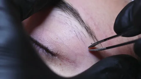 Removing excess eyebrows on the face of a young Caucasian girl Stock Footage 252127211
