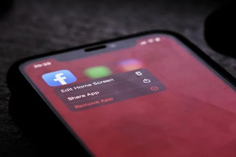 Removing Facebook mobile application from cell phone Stock Photos