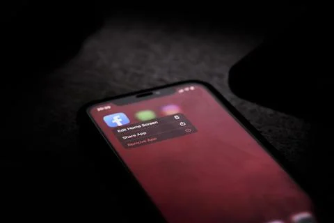 Removing Facebook mobile application from cell phone Stock Photos