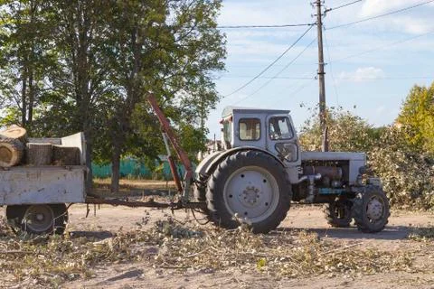 Removing fallen tree with tractor and loader Stock Photos
