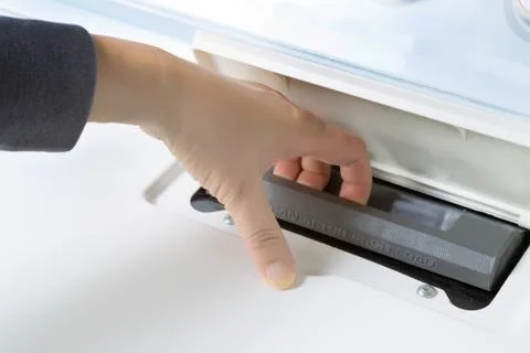 Removing filter from dryer machine Stock Photos