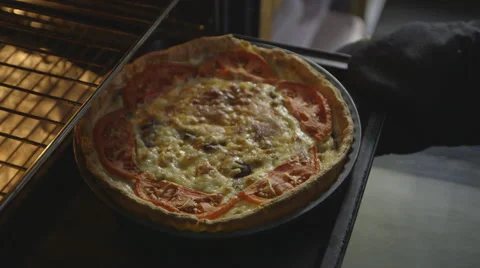 Removing a flan from an oven Stock Footage 64050286