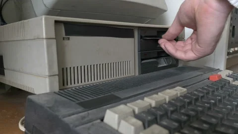 Removing a floppy disk from old personal computer Stock Footage 91373988