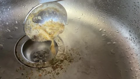 Removing foam from boiling goat meat broth with skimmer during traditional Stock Footage 345728559