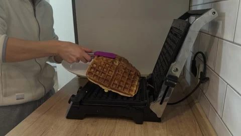 Removing Four Waffles From Waffle Maker With Spatula Placing On Plate Stock-Footage 341864496