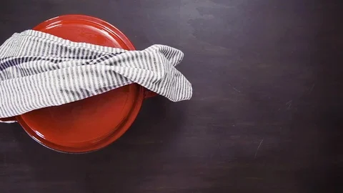 Removing freshly baked cornbread muffins from metal muffin pan. Stock Footage 96359063