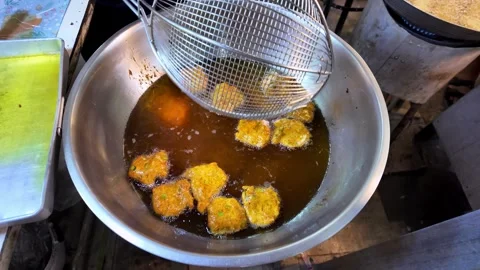 Removing Fried Fish Cakes from Hot Oil Street Food Thailand 4K Stock Footage 333981683