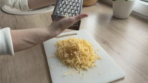 Removing Grated Cheese From Grater Onto Board Cooking Ingredient Preparation Video stock 336447822