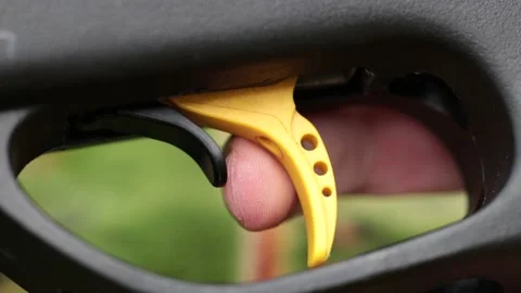 Removing the gun safety trigger with a finger and getting ready to shot. Stock Footage 194789265