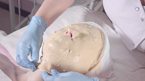 Removing the healing mask from the face Stock Footage 76451046