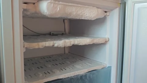 Removing ice buildup from freezer and preparing it for use Stock Footage 339592682