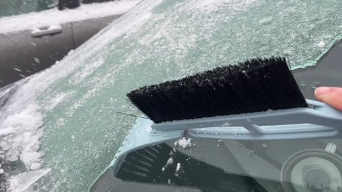Removing ice from car windshield with scraper in winter conditions. Stock Footage 328026105