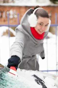 Removing ice from the car windshield selective focus on ICE cleaner Stock Photos