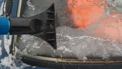 Removing ice from the Windows of an old car Stock Footage 120551397