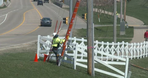 Removing Ladder from Utility Pole - Utility Worker Stock Footage 128146764
