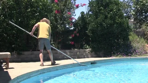 Removing leaves from pool Stock Footage 25038440