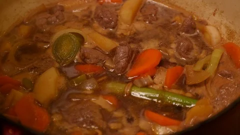Removing the lid from a casserole dish Stock Footage 121449601