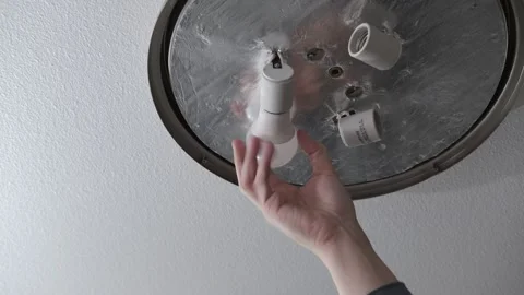 Removing a lightbulb from the socket Stock Footage 303674998