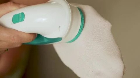 Removing lint from a pink sock  Stock Footage 308641606