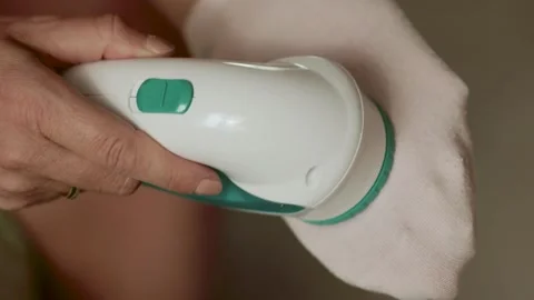 Removing lint from a pink sock  Stock Footage 308641608