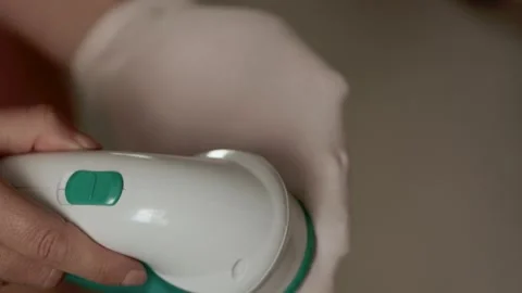 Removing lint from a pink sock  Stock Footage 308641611